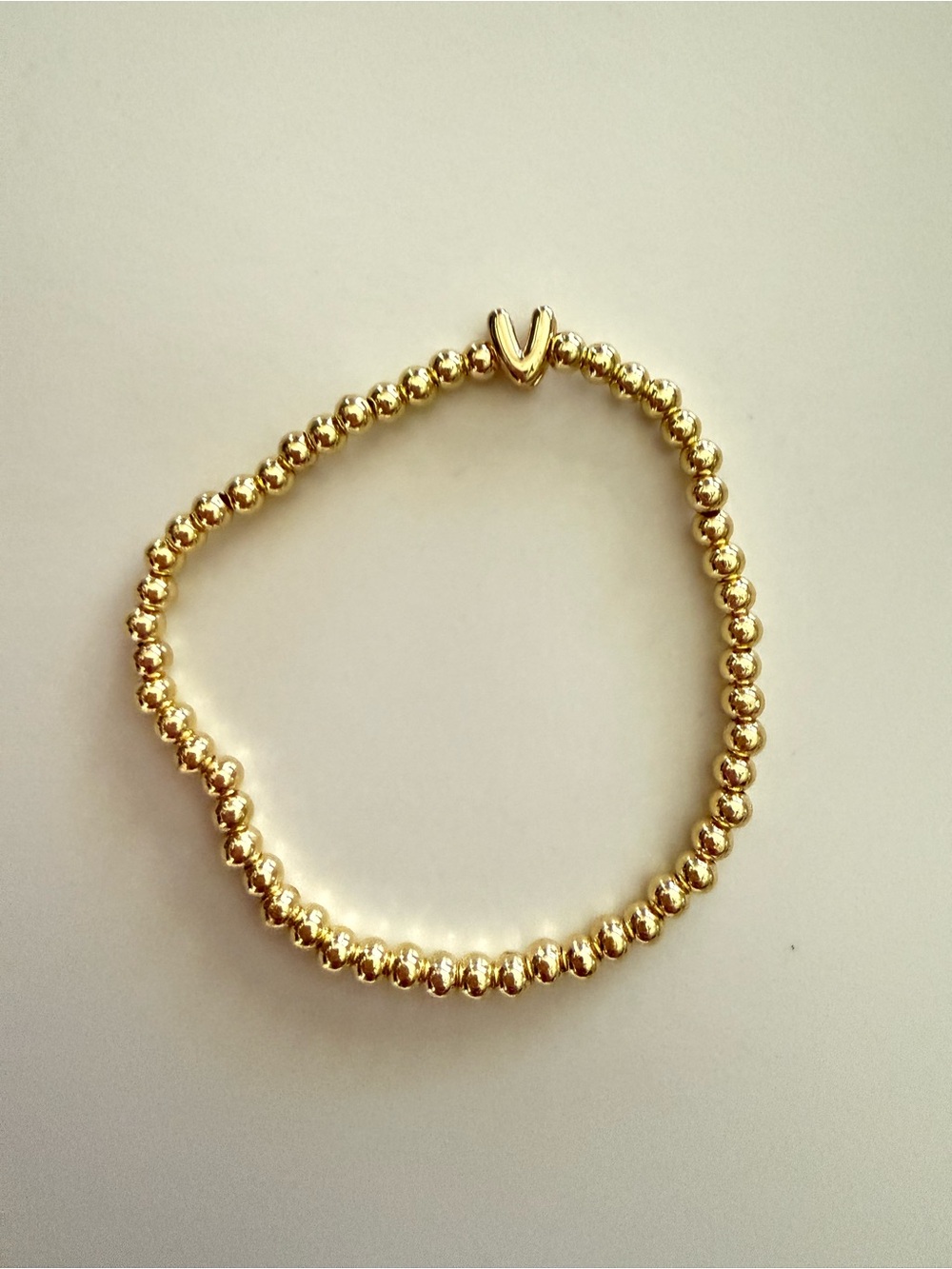 Gold Beaded Stretch Bracelet with V Initial